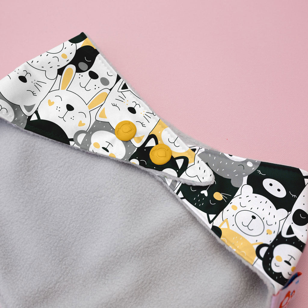 Fabric with cartoon animal pattern on a pink background