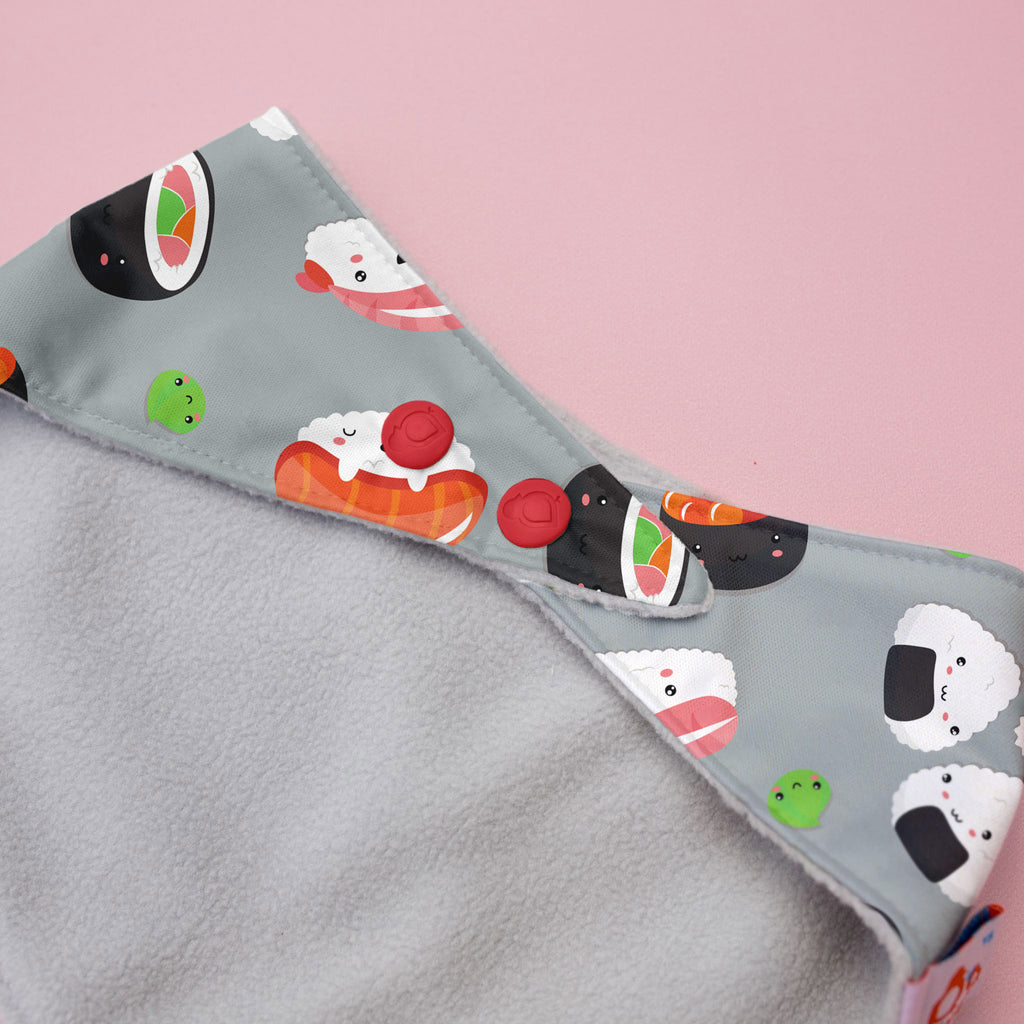Gray fabric with cartoon sushi design on a pink background