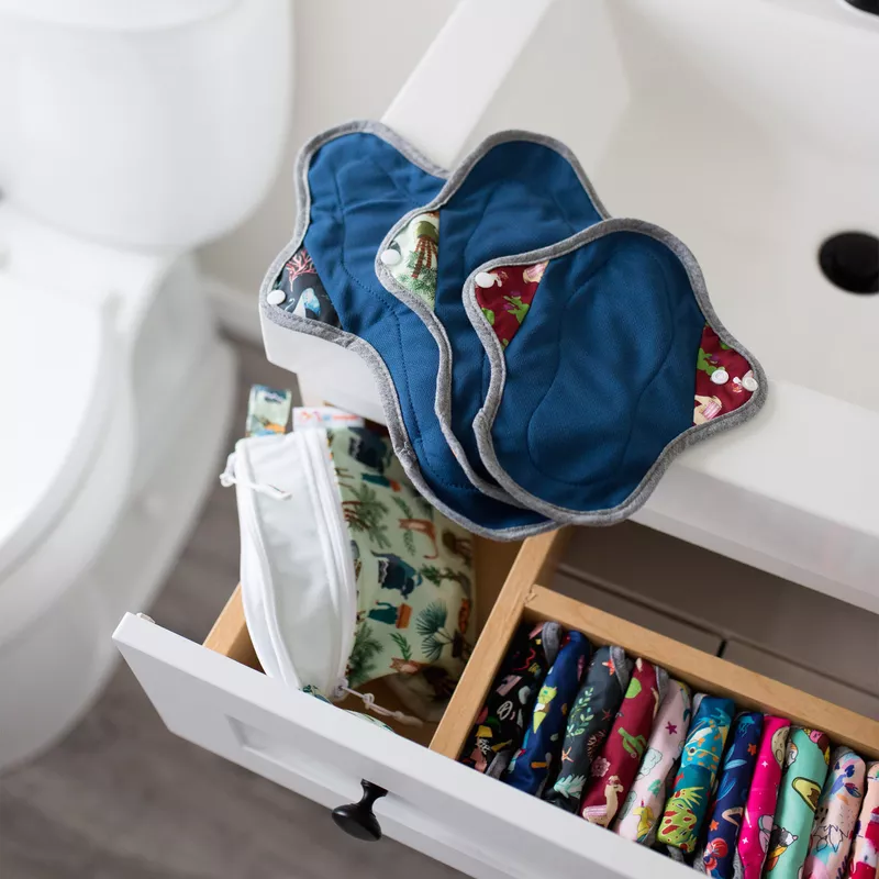 reusable period pads lined up and out of a dresser 