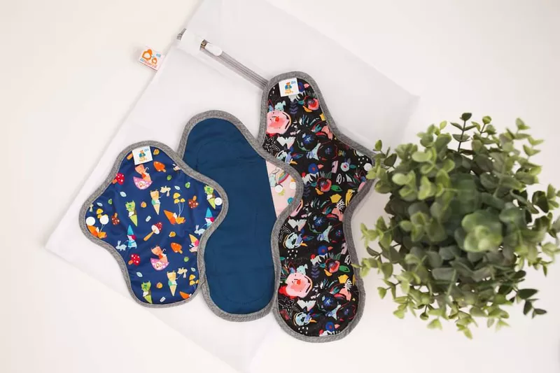 reusable menstrual pads next to a plant